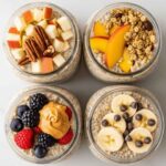 Four jars of overnight oats recipe topped with apples and pecans, peaches and granola, berries with peanut butter, and bananas with chocolate chips